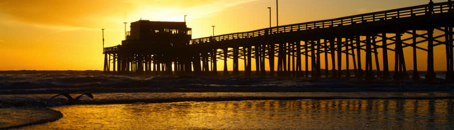 newport beach california pier at sunset in the golden silhouette